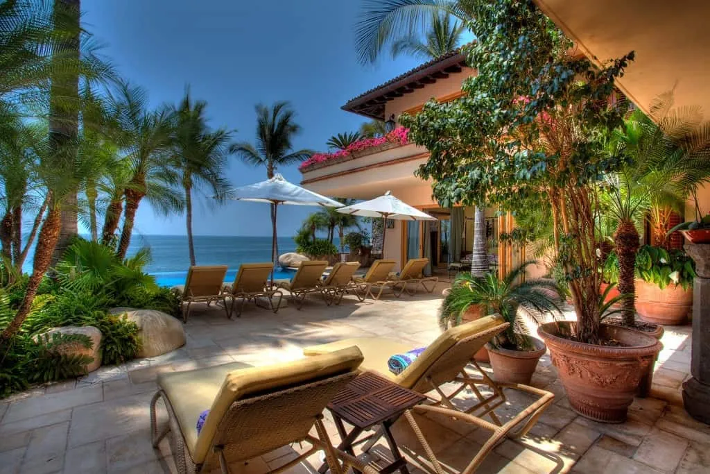 The pool and palm-shaded terrace of Villa Amapas South in lower Conchas Chinas, Puerto Vallarta, above Banderas Bay