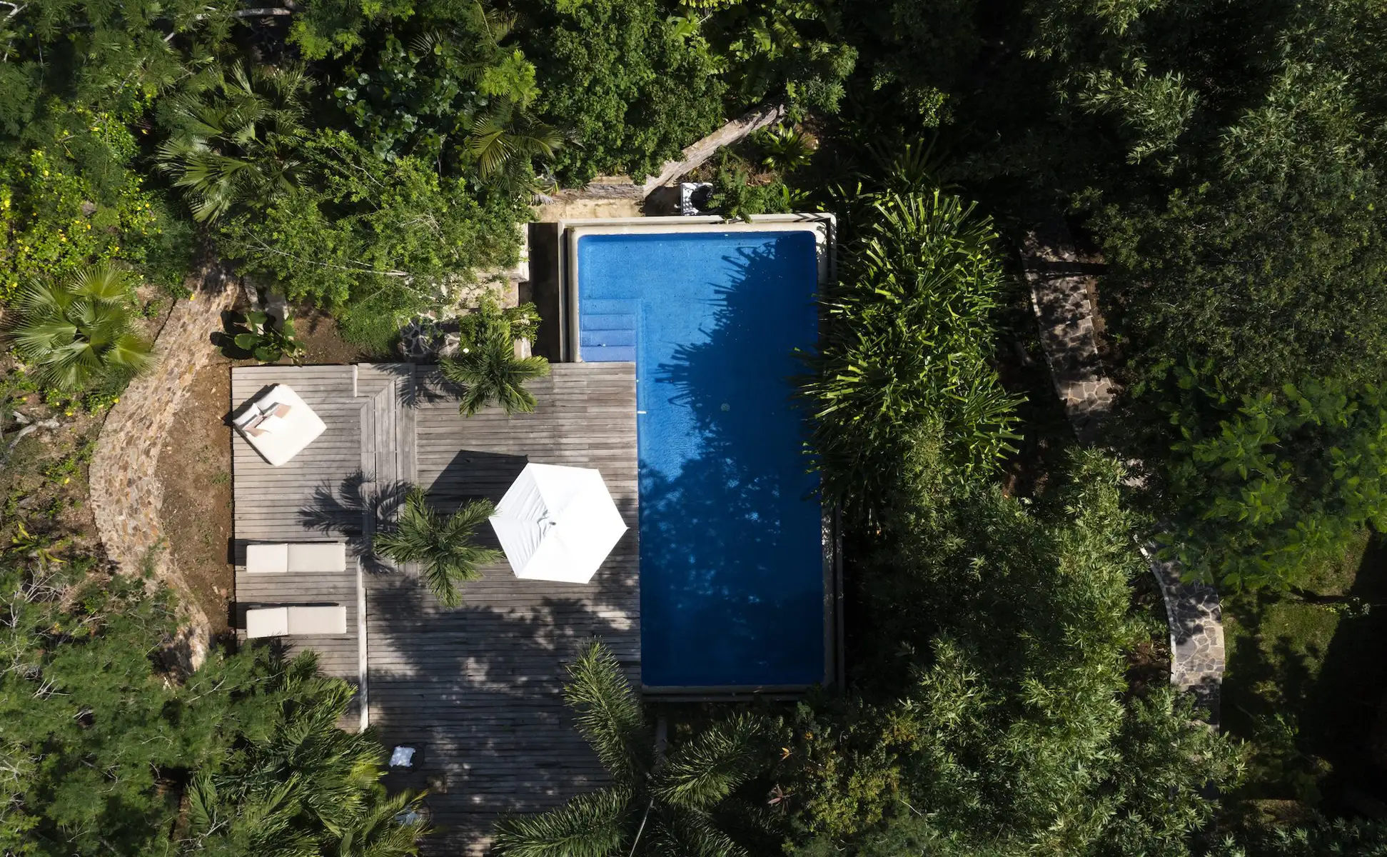 Aerial view of Casa Infinito and its pool surrounded by tropical dry forest in Costa Careyes on the Costalegre