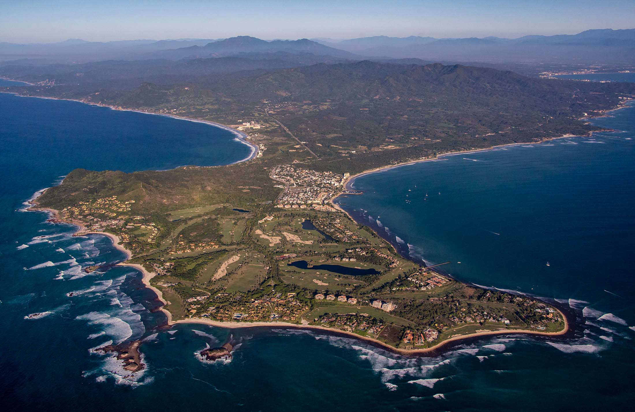 Aerial view of the Punta Mita peninsula, showing the golf course, the gated development, and the village along Banderas Bay.